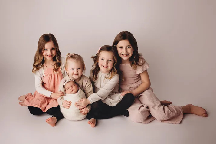 Four children and a newborn baby smiling together at Align Chiropractic PA